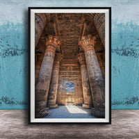 an ancient Egyptian temple with towering columns and intricate carvings, set against a blue wall with a textured pattern.