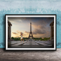 A framed photograph of a woman in a white dress dancing in front of the Eiffel Tower in Paris, France, with a blue sky and clouds in the background.