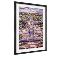 A framed watercolor painting depicting a cityscape with a castle-like structure in the background, surrounded by lush greenery and a cloudy sky.