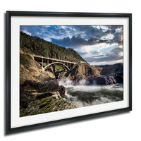 a scenic landscape with a bridge spanning over a rushing river, surrounded by rocky cliffs and lush greenery.