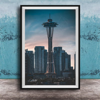 A framed photograph of the Space Needle, a famous landmark in Seattle, Washington, with the city skyline in the background.