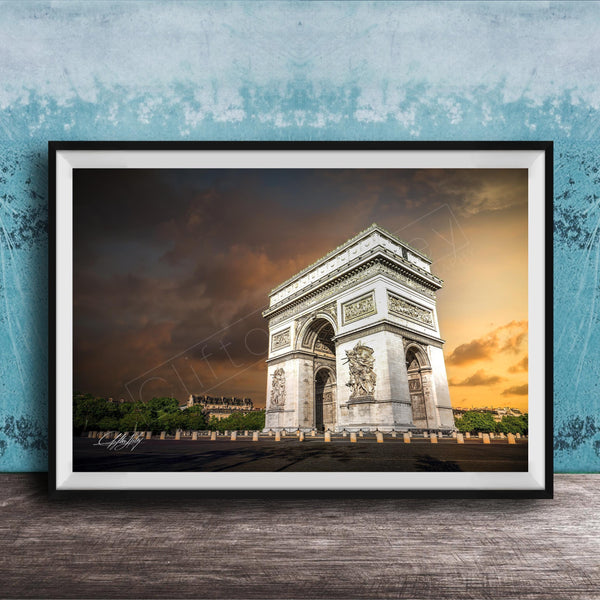 a large, ornate archway with intricate carvings, set against a dramatic sky with clouds and a warm, orange glow.