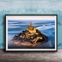 a picturesque island with a castle-like structure on top, surrounded by a body of water.