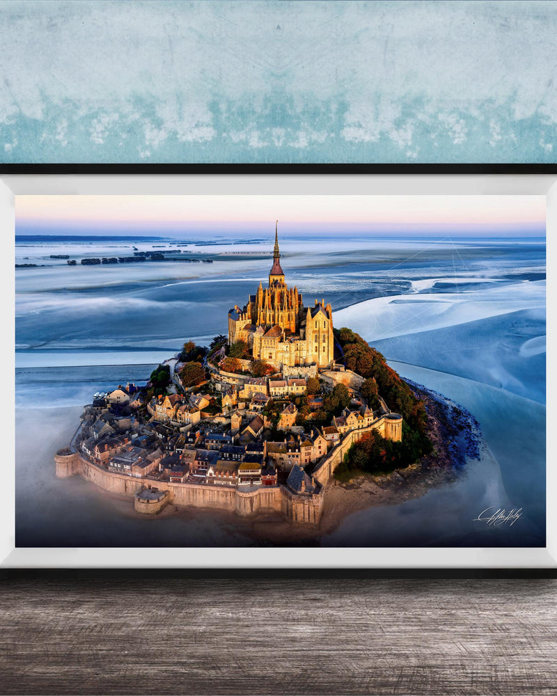 a picturesque island with a castle-like structure on top, surrounded by a body of water.
