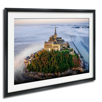 a picturesque island with a large, ornate building perched on its rocky outcropping, surrounded by lush greenery.