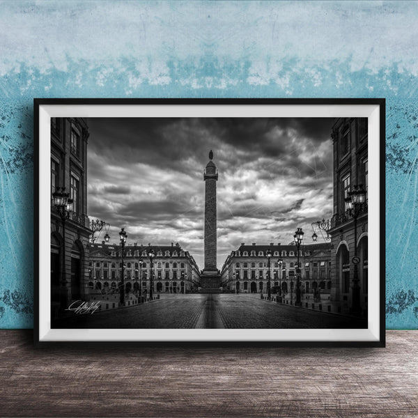 A black and white photograph of the Eiffel Tower in Paris, France, with a cloudy sky in the background.