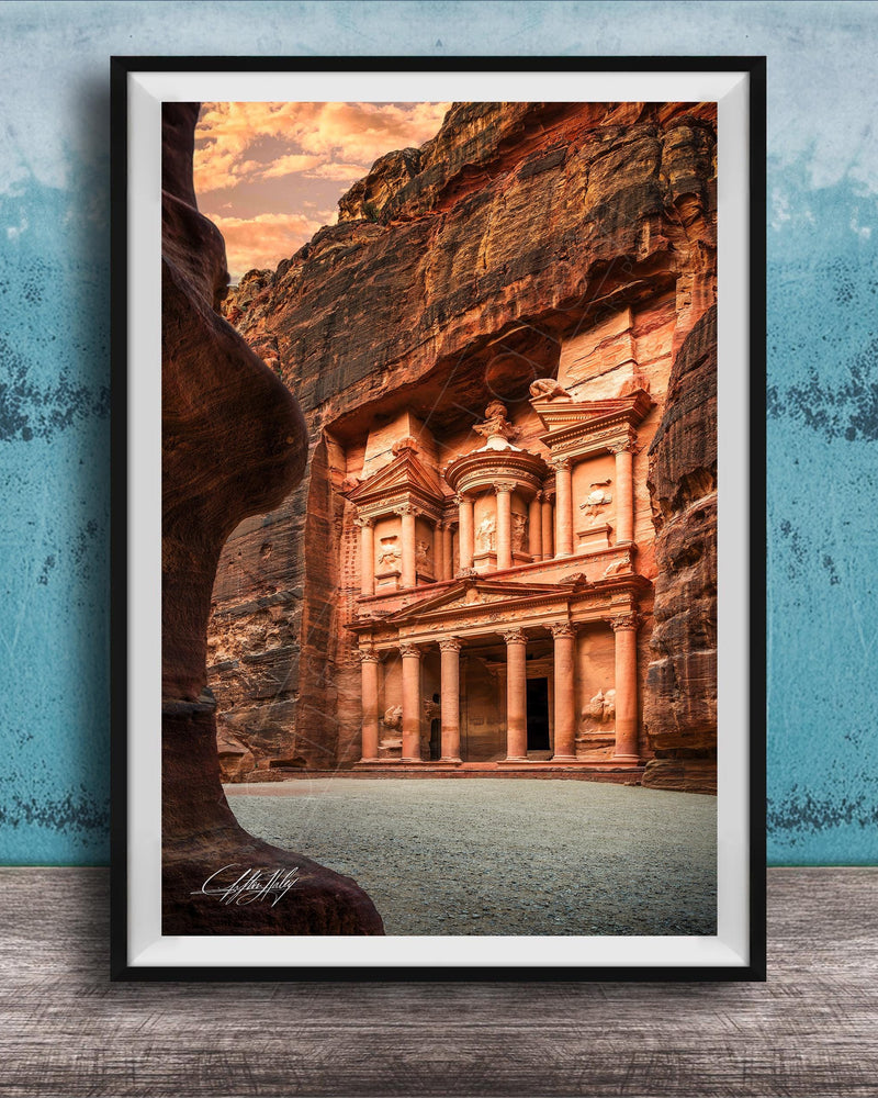 A framed photograph of the ancient ruins of Petra, a famous archaeological site in Jordan, featuring the iconic Treasury of the Kings carved into the rock face.
