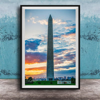 the Washington Monument, a tall obelisk, against a colorful sunset sky with clouds.