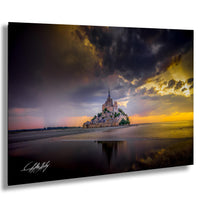 a large castle perched on a small island, with a dramatic sky and clouds in the background.