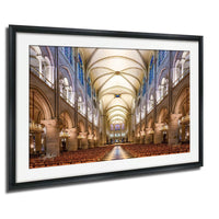 a grand cathedral with a high vaulted ceiling, ornate architectural details, and rows of wooden pews leading to a central altar.