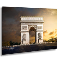 the Arc de Triomphe, a famous monument located in Paris, France. The monument is a large white arch with intricate carvings and sculptures, standing against a dramatic sky with clouds.