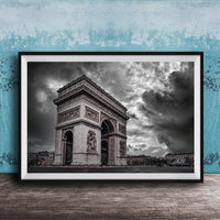 The image is a framed photograph of the Arc de Triomphe in Paris, France, with a dramatic sky in the background.