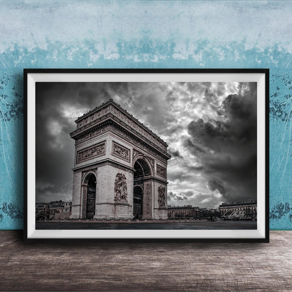 The image is a framed photograph of the Arc de Triomphe in Paris, France, with a dramatic sky in the background.
