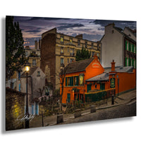 a charming street scene in a European city at dusk, with colorful buildings, a restaurant, and a lamppost.