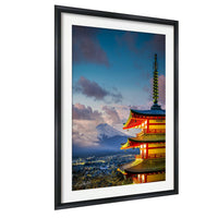 A framed photograph of the Shinto pagoda in Japan, with a mountain in the background and a colorful sky above.