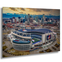 an aerial view of a large sports stadium, likely a football stadium, with the city skyline in the background.