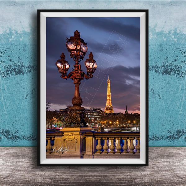 a cityscape with a lit-up lamppost and the Eiffel Tower in the background, set against a dark sky.