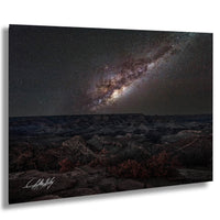 a breathtaking view of the night sky, showcasing a stunning galaxy with vibrant colors and intricate patterns. The vast expanse of space is filled with countless stars, creating a mesmerizing spectacle. The landscape below is rugged and rocky, adding a sense of depth and scale to the scene. The image is a captivating representation of the wonders of the universe, inviting the viewer to marvel at the beauty and complexity of the cosmos.