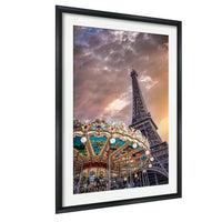 a carousel in front of the Eiffel Tower, with a dramatic sky in the background.
