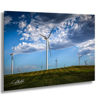 A field of wind turbines against a blue sky with clouds, creating a picturesque landscape.
