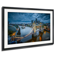 The image is a framed photograph of the London skyline at night, featuring the iconic Tower Bridge and the River Thames.