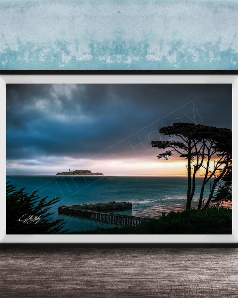 a serene coastal scene at sunset, with a wooden pier extending into the calm, blue waters. The sky is filled with clouds, creating a dramatic backdrop for the tranquil setting.