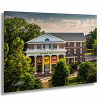 A brick building with a white pediment and columns, identified as "PEARDSON HALL", surrounded by trees and a grassy area.