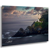 A picturesque coastal scene with a lighthouse perched atop a rocky cliff overlooking the ocean. The sky is filled with clouds, creating a dramatic backdrop for the lighthouse. The image is a captivating blend of natural beauty and maritime architecture.