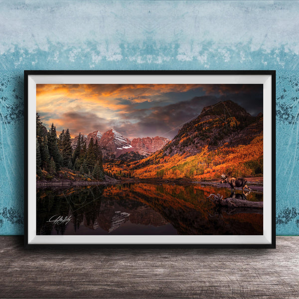 a serene mountain landscape with a lake reflecting the vibrant colors of the sky and surrounding trees.