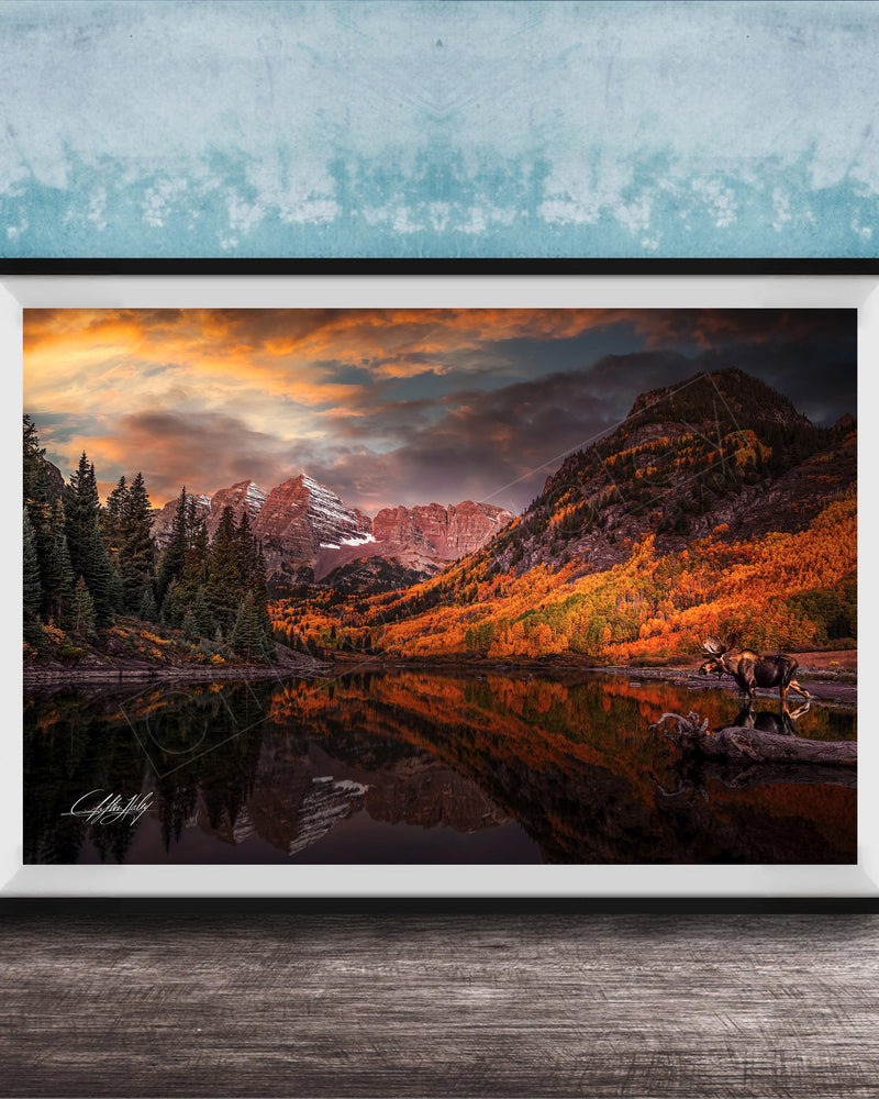 a serene mountain landscape with a lake reflecting the vibrant colors of the sky and surrounding trees.