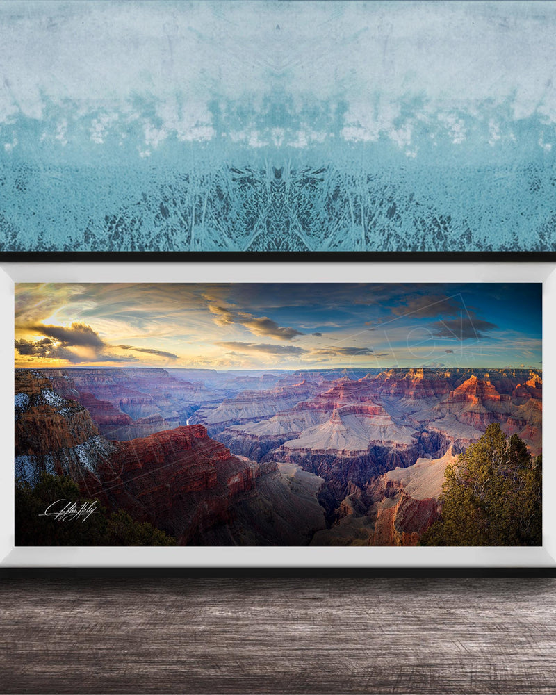 A framed photograph of the Grand Canyon, showcasing the vast and breathtaking landscape with its dramatic rock formations and vibrant colors at sunset.