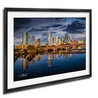 a city skyline with tall buildings reflected in the water below, creating a beautiful and serene scene.