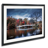 a serene landscape with a white bridge spanning a calm river, surrounded by a vibrant display of autumn foliage.