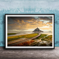 a picturesque landscape with a winding road leading to a castle on a grassy island, set against a dramatic sky with clouds and a warm, golden glow.