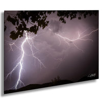 a dramatic lightning storm with bolts of bright white light illuminating the dark sky.