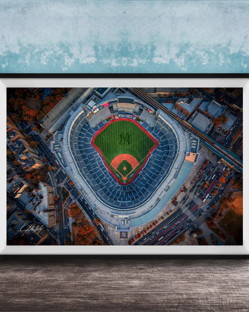 The image is an aerial view of a baseball stadium, specifically the New York Yankees stadium, with the field and surrounding buildings visible.