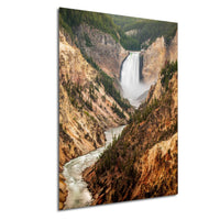 A stunning waterfall cascading down a rugged, mountainous landscape, surrounded by lush greenery and rocky terrain.