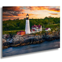 A picturesque lighthouse stands on a rocky cliff overlooking a serene body of water, with a stunning sunset sky in the background.