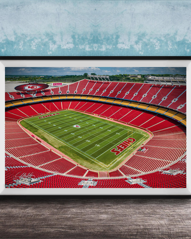 The image is a framed photograph of a football stadium, specifically Kansas City Chiefs Stadium, with a view of the field and seating areas.