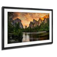 a serene landscape with a river flowing through a mountainous terrain, surrounded by lush greenery and towering cliffs. The sky is filled with vibrant colors, creating a stunning backdrop for the scene.