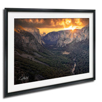 a breathtaking view of a mountainous landscape at sunset, with the sun setting behind the mountains and casting a warm, golden glow over the scene.