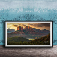 The image is a framed photograph of a scenic landscape with mountains and a sunset sky.