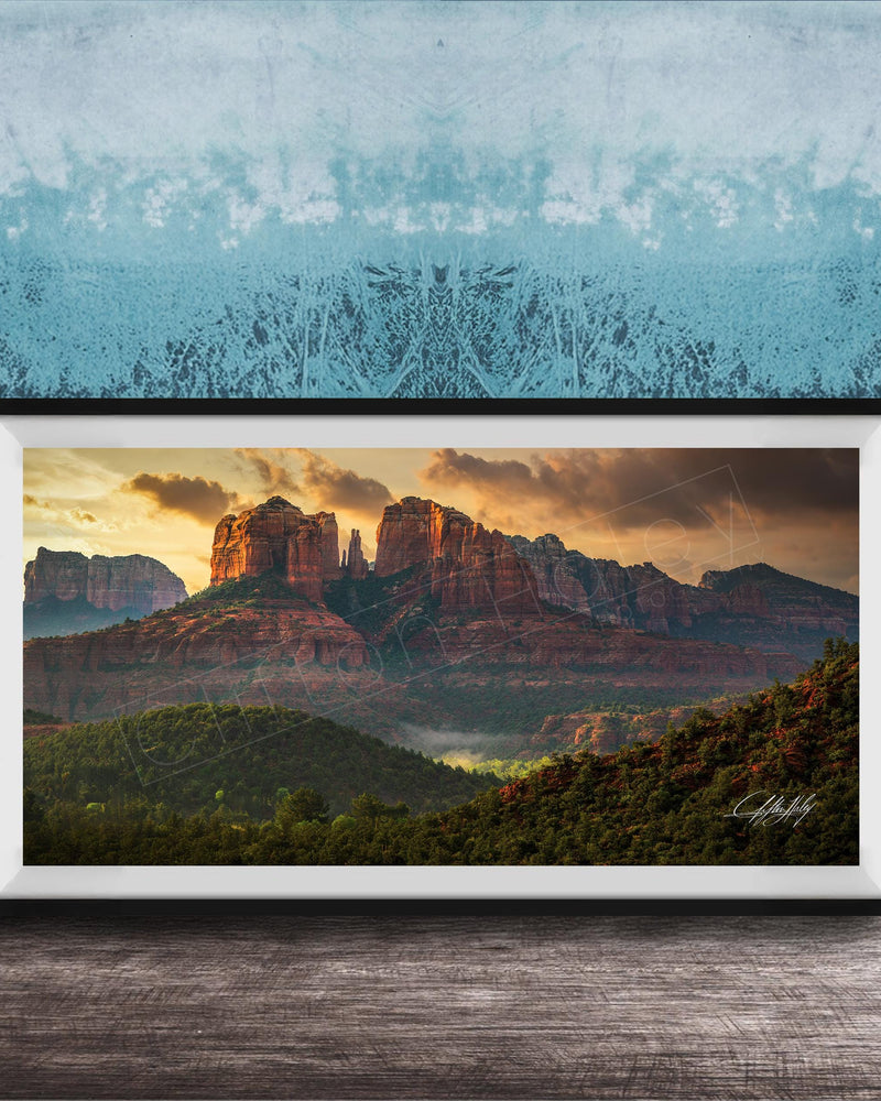 The image is a framed photograph of a scenic landscape with mountains and a sunset sky.