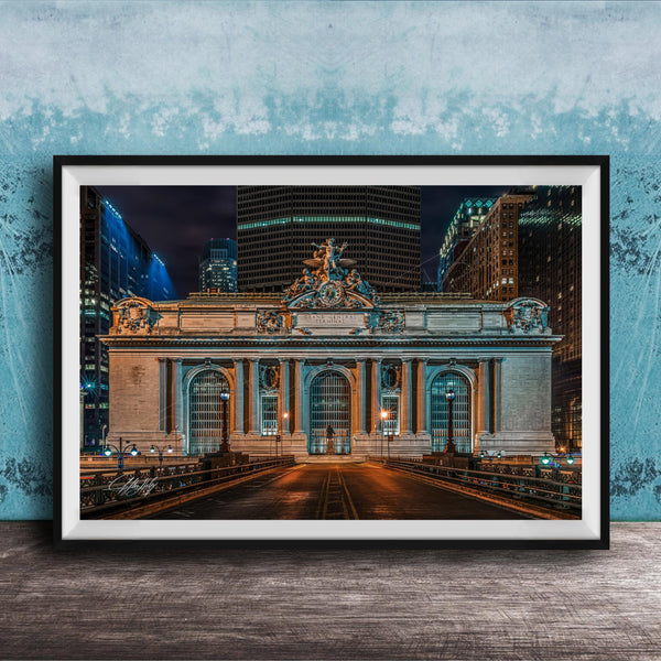 A framed photograph of the Grand Central Terminal in New York City at night, with the terminal's ornate facade and surrounding skyscrapers illuminated against a dark sky.