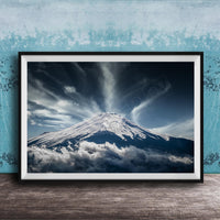 A framed photograph of a snow-capped mountain peak, with dramatic clouds and a dramatic sky in the background.