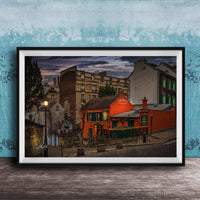 a charming street scene in a European city, with colorful buildings, a red building with a green awning, and a lamppost in the foreground.