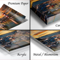 four different views of a printed artwork depicting a cityscape at sunset, with a focus on the boats in the water.