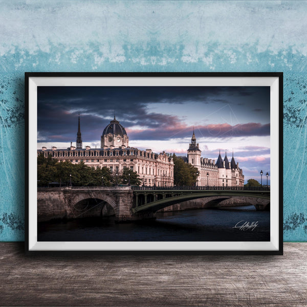 a picturesque scene of a historic building with a dome and a bridge spanning a river, set against a dramatic sky with clouds.