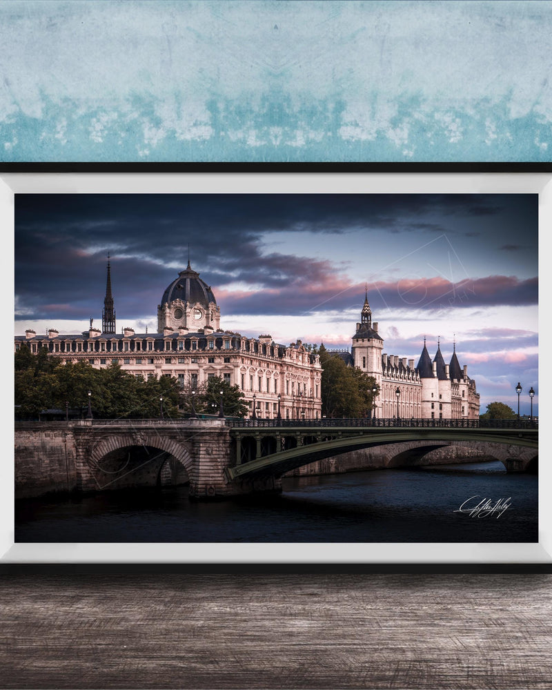 a picturesque scene of a historic building with a dome and a bridge spanning a river, set against a dramatic sky with clouds.