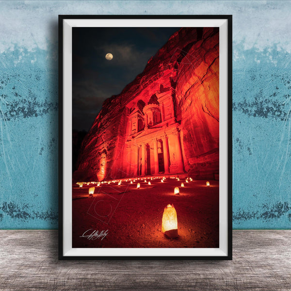 a large, illuminated building with a prominent dome, surrounded by a large number of lit candles, creating a warm and inviting atmosphere.